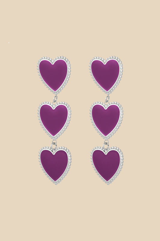 Amore oorbellen met drie sierlijke paarse hartjes op een rij